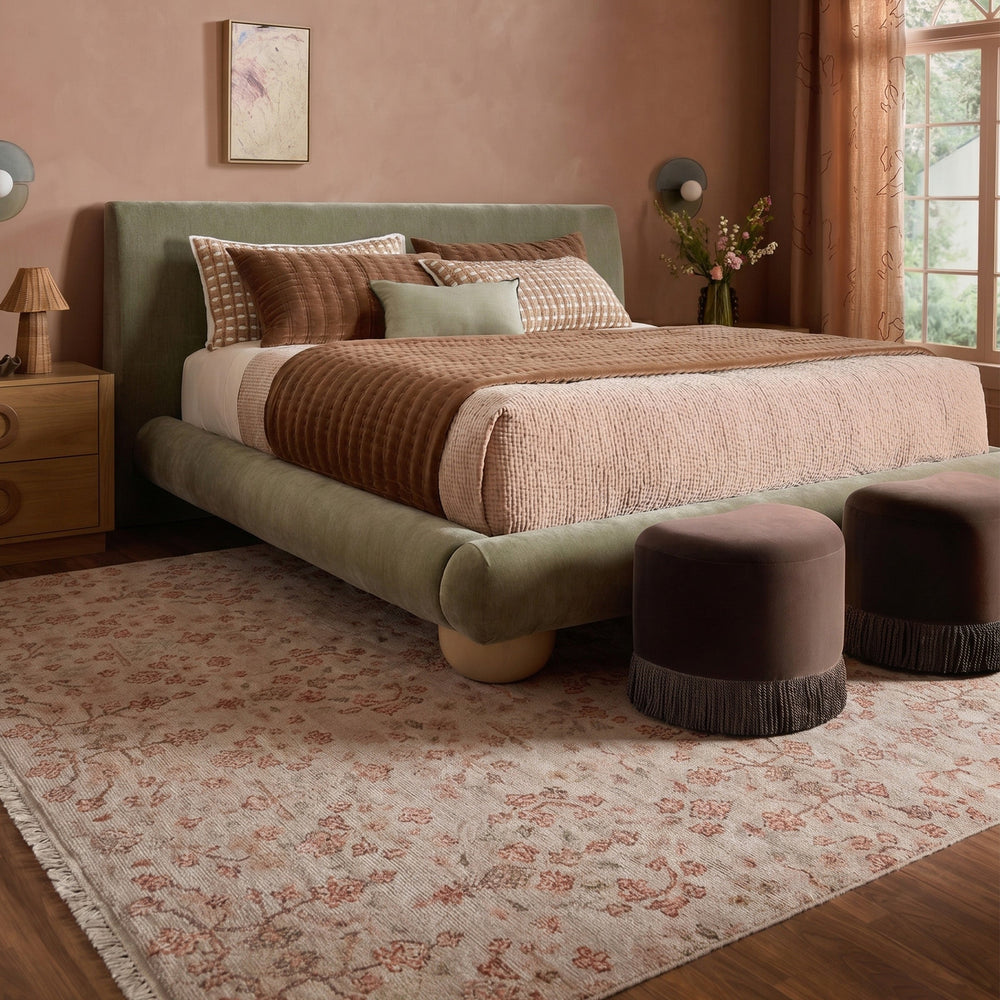 LOOMY Wanderlust hand-knotted rug styled in a warm bedroom with a green bed