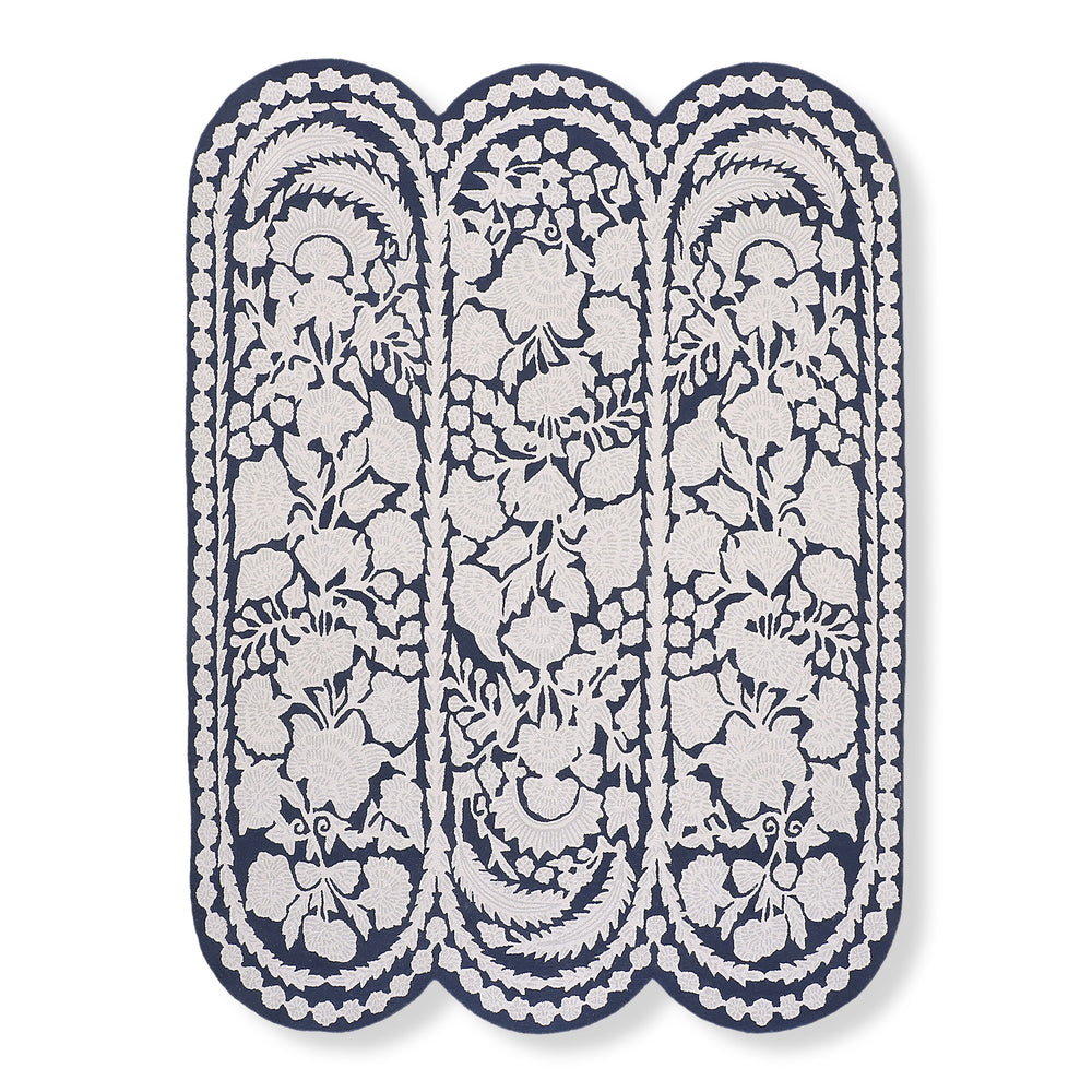 Chinoiserie wool tufted rug in navy and ivory with a scalloped three-lobe shape and floral pattern