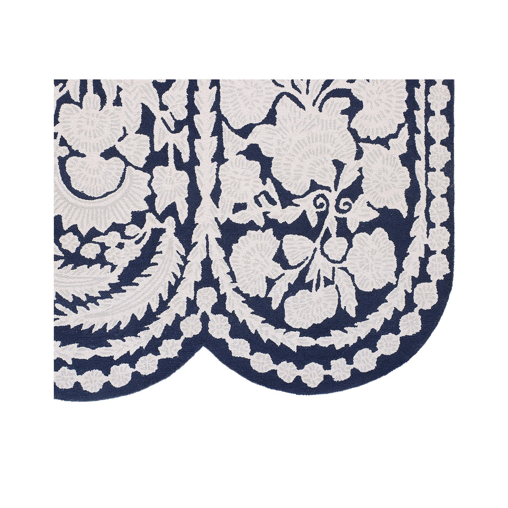 Scalloped edge of the Chinoiserie wool tufted rug showing the navy border and ivory floral detail