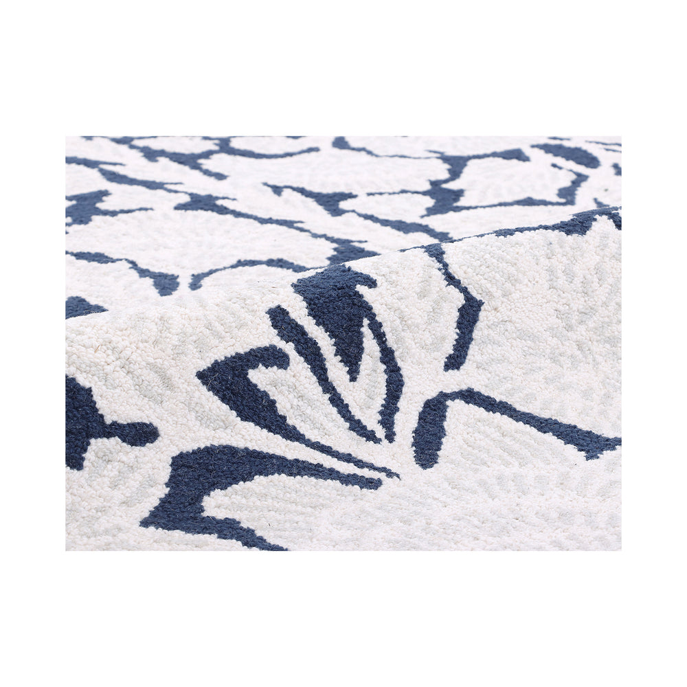 Close-up of the hand-tufted ivory floral motif on the navy ground of the Chinoiserie rug