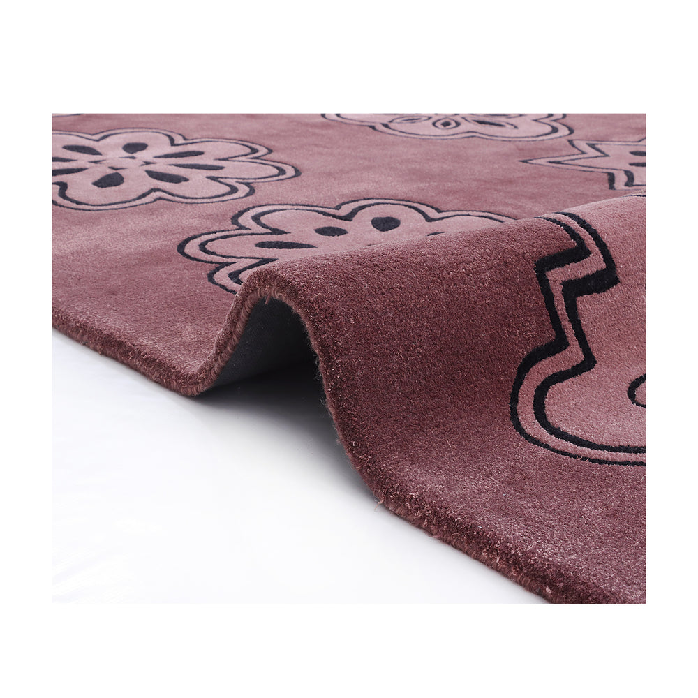 Corner of the Dotta rug folded back to show the plush half-inch pile and silky viscose sheen